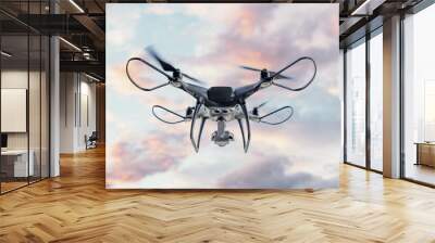 Modern drone with a camera flies in the sky. Wall mural