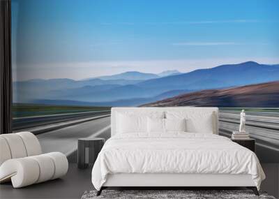 Mountain highway with blue sky and rocky mountains on a background Wall mural