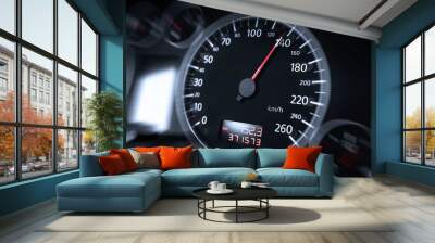 The speedometer of a modern car shows a high driving speed. Added motion blur. Wall mural