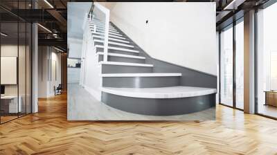 Luxurious modern interior design in a multi-storey building with an elegant white wooden staircase with details Wall mural