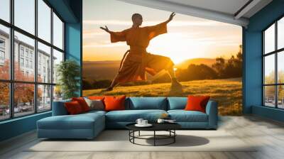 shaolin  monk practicing kung fu outside on the grass at sunset  Wall mural