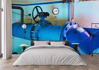 Valves installed on tubes painted blue. Industrial background. Wall mural