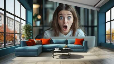 Young businesswoman manager employee with shocked excited face expression looking on laptop, working at office. Career growth and success at work. Wall mural