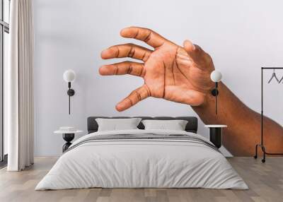 African american black man hand hanging something blank isolated on a white background. Close-up. Wall mural