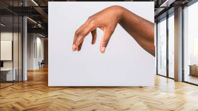 African american black man hand hanging something blank isolated on a white background. Close-up. Wall mural