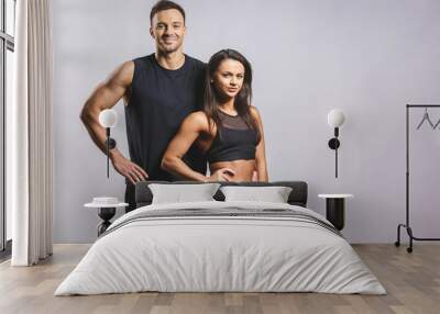 Athletic man and woman isolated over white background. Personal fitness instructor. Personal training. Wall mural