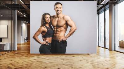 Athletic man and woman isolated over white background. Personal fitness instructor. Personal training. Wall mural