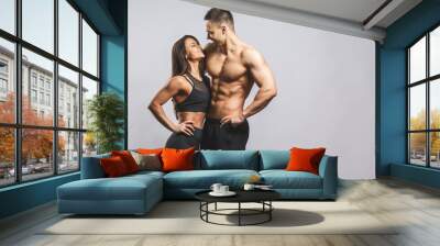 Athletic man and woman isolated over white background. Personal fitness instructor. Personal training. Wall mural