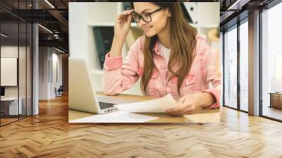 Close-up business woman signing documents. Typing on laptop close-up. Meeting report in progress. Wall mural