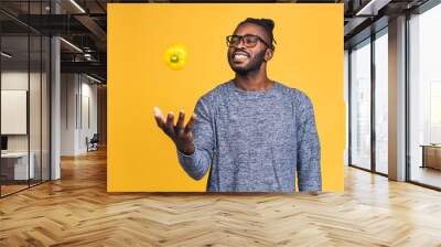 Healthy african american black man holding pepper isolated over yellow background. Diet healthy food concept. Vegan, vegetarian, lifestyle concept. Wall mural