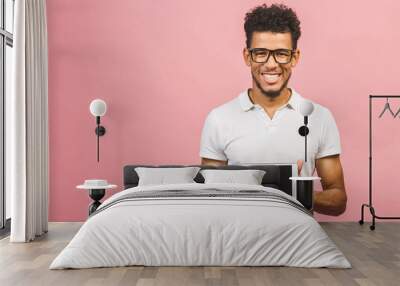 Laughing Young African American Male Holding a Touch Pad Tablet PC  Isolated against pink Background Wall mural