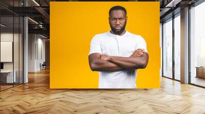 Portrait of handsome serious young african american man iisolated yellow background. Wall mural