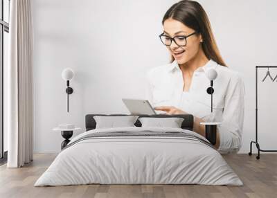 Portrait with copy space empty place of pretty charming confident trendy woman in classic shirt having tablet in hands isolated on white background Wall mural