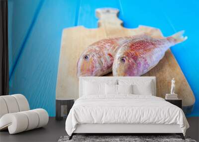 Raw red mullet on board Wall mural