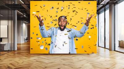 Winner! Cheerful african american young man dancing over yellow background. Wall mural