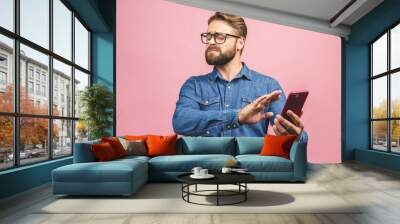 Young handsome business man talking on the phone over pink isolated background with open hand doing stop sign with serious and confident expression, defense gesture Wall mural