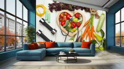 Fresh vegetables. Diet, a healthy lifestyle. Sport, dumbbells and a skipping rope on a white background Wall mural