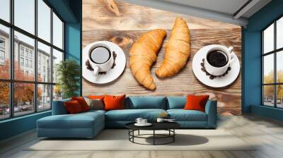 Two cups of coffee and a croissant on a wooden table Wall mural