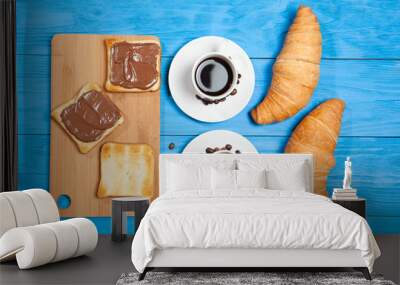 Two cups with coffee, croissant and toast with chocolate on a blue wooden table Wall mural