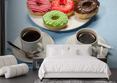 Two cups with coffee and donuts on a blue table Wall mural