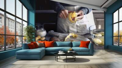 Peeling potatoes on the wooden table horizontal Wall mural