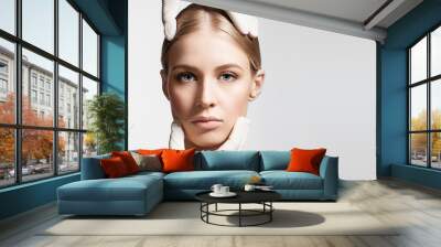 Beautiful female face in the hands of a doctor cosmetologist gloves Wall mural