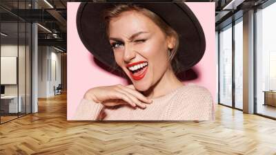 Close-up fashion portrait of gorgeous lady expressing happiness. Stylish female with beautiful smile and perfect makeup posing in studio on pink background Wall mural