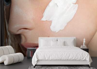 Close-up of cream on a woman's face with clean skin Wall mural