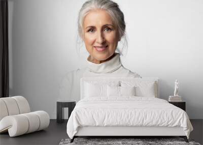 Elegant old woman with natural makeup and clean perfect skin. Portrait of a pretty model with gray hair on a white background Wall mural