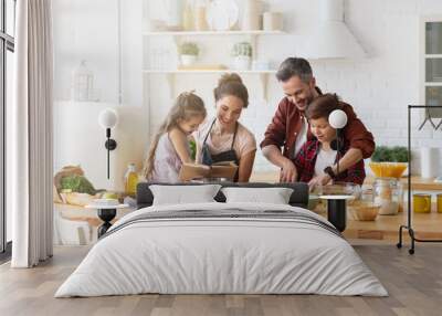 Happy family cooking together on kitchen with kids.  Wall mural