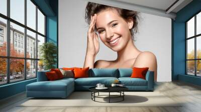 portrait of a smiling young pretty woman with natural make-up and clean skin Wall mural