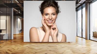 Portrait of a smiling young pretty woman with natural make-up Wall mural