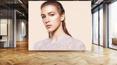 Portrait of a stylish woman model with natural make-up and wet hair on a beige background in lacy clothes Wall mural