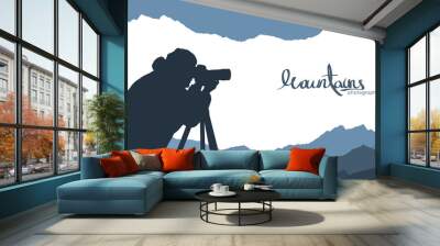 Mountains template background with silhouette of nature photographer. Wall mural