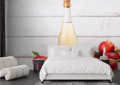 Bottle of homemade organic apple cider with fresh apples in box on wooden background. Space for text Wall mural