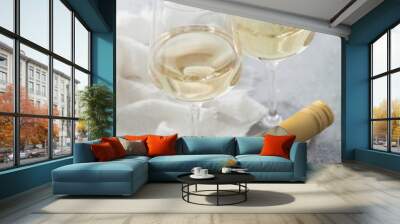 Bottle of white wine with two crystal glasses and steel corkscrew on light background. Wall mural