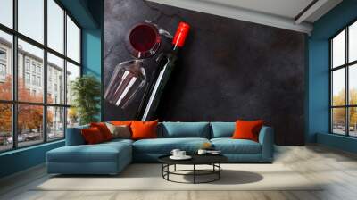 Elegant glass and bottle of red wine on stone kitchen table background. Top view. Space for text Wall mural