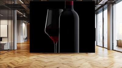 Glass of red wine with bottle close up on black Wall mural