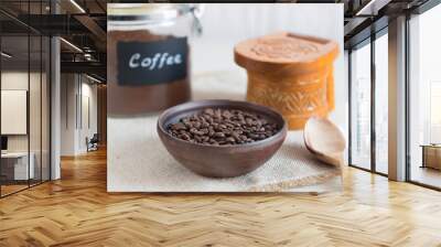 Coffee beans in a bowl on the old wooden table. Wall mural