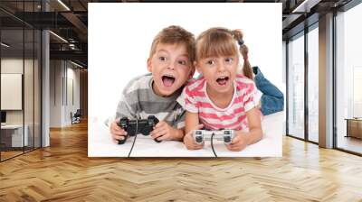 Happy girl and boy playing a video game Wall mural