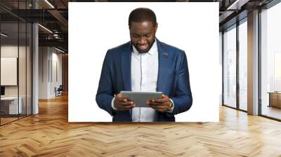 Afro american office worker with computer tablet. Smiling black businessman with digital tablet on white background. Manager working on pc device. Wall mural