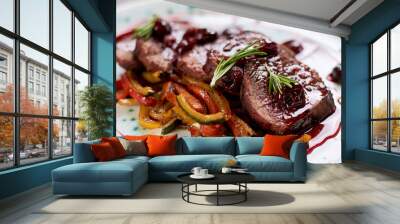 Appetizing beef in sweet sauce close up. Chopped beef meat in cherry sauce with vegetables on plate. Delicious european cuisine. Wall mural