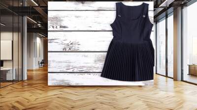 Black pleated classic dress for schoolgirl. Classic signature school girl sleeveless dress and copy space. Cute cotton girl dress for school wear. Wall mural