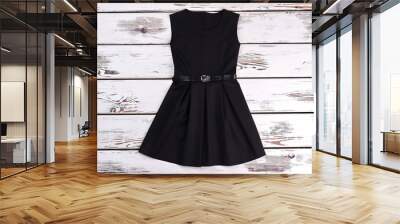 black sleeveles short cotton dress. a-line black cotton girls dress on old wooden background. girls  Wall mural