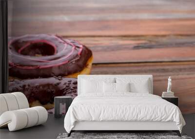 donuts on wooden background. delicious cakes with chocolate glaze. space for text. Wall mural