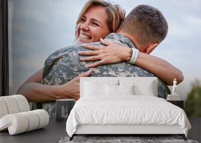 Happy woman hugging his husband came back from army. Smiling cheerful caucasian girlfriend embracing a soldier. Wall mural