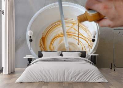 House renovation concept. Close up shot of mixing white and brown paint in bucket. Wall mural