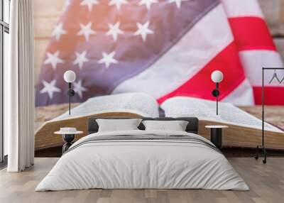 Open book and american flag. Open book on wooden surface. Value your independence. Freedom for every man. Wall mural