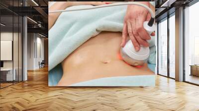 rf skin tightening, belly. hand of cosmetician, female body. non surgical body sculpting. Wall mural