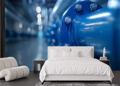 Pipes and valves in a modern industrial facility showcasing blue metallic components and a clean interior environment Wall mural